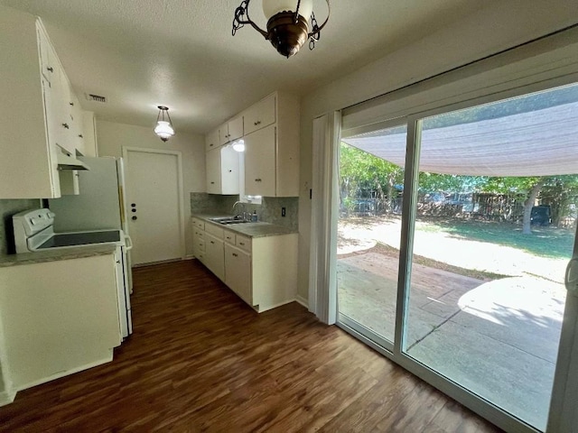 kitchen featuring sink, white electric range, white cabinetry, dark hardwood / wood-style flooring, and decorative light fixtures