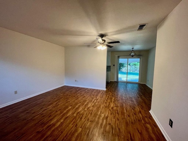 unfurnished room with dark hardwood / wood-style floors and ceiling fan