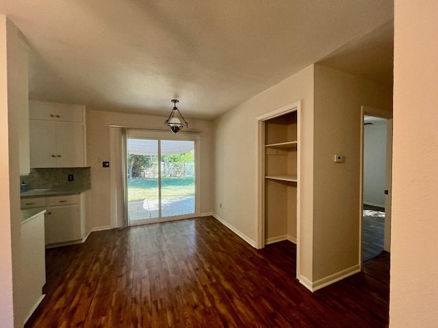 unfurnished dining area with dark hardwood / wood-style flooring