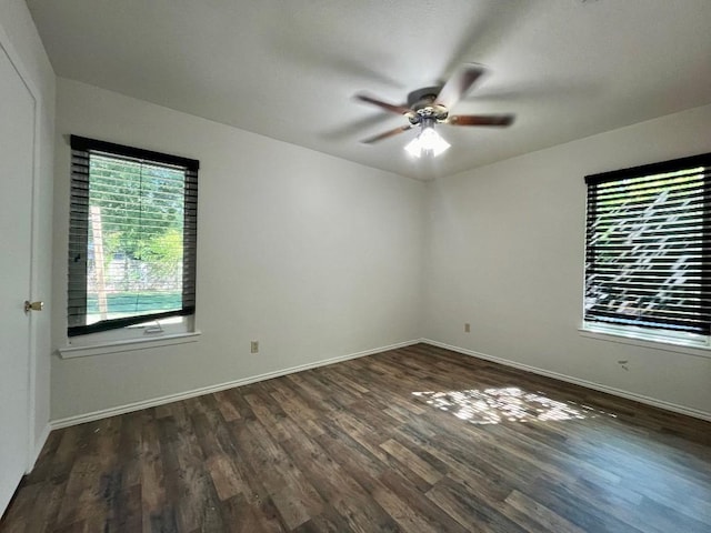 empty room with dark wood-type flooring and ceiling fan