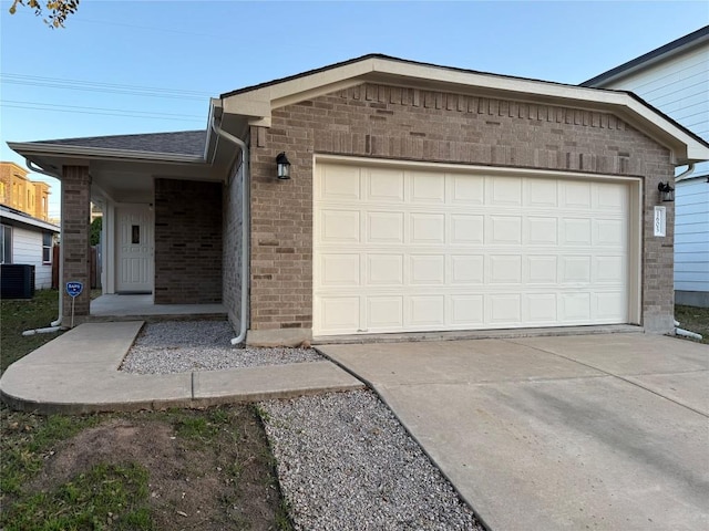 ranch-style home with cooling unit and a garage