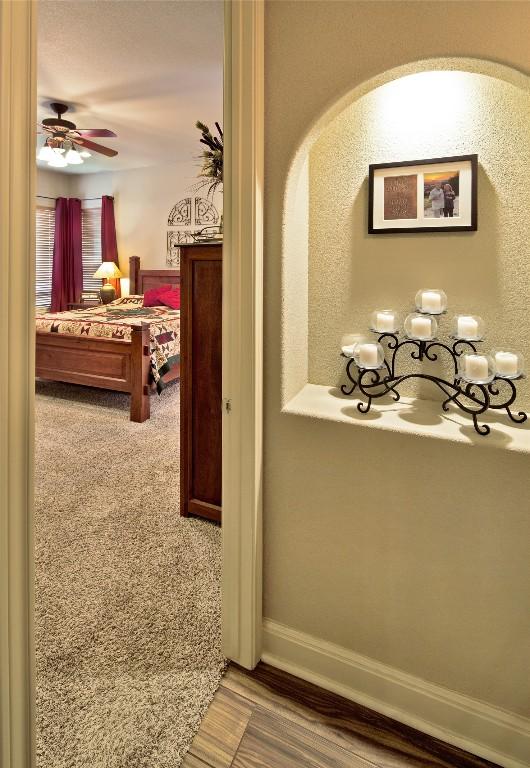 hall featuring hardwood / wood-style floors and a notable chandelier