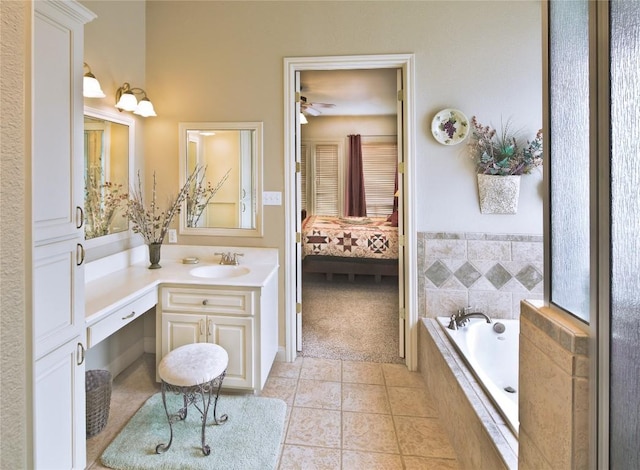 bathroom with vanity, tiled bath, and tile patterned floors