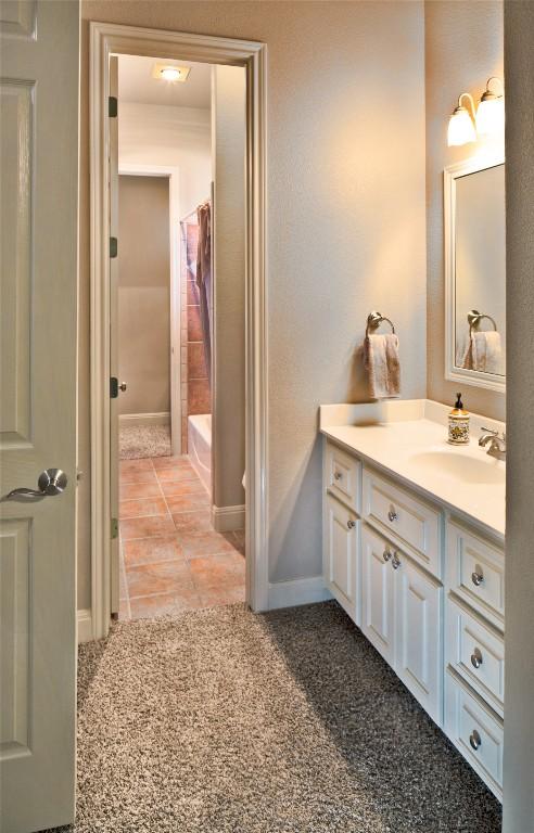 bathroom with vanity, tile patterned flooring, and shower / bath combination with curtain