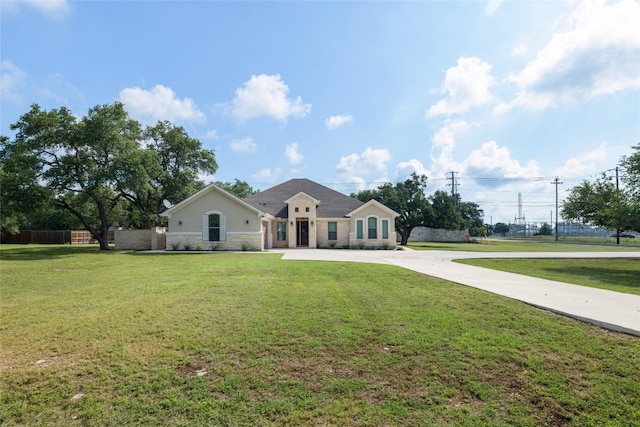 ranch-style home featuring a front yard