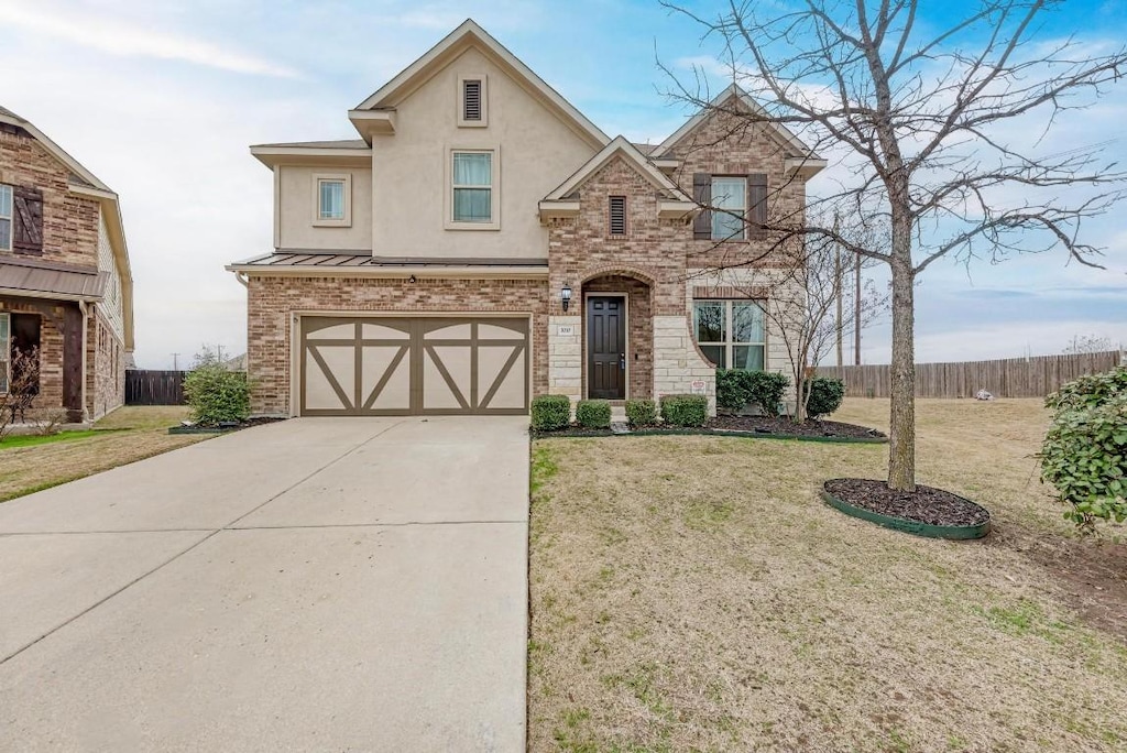 view of front facade with a garage and a front yard