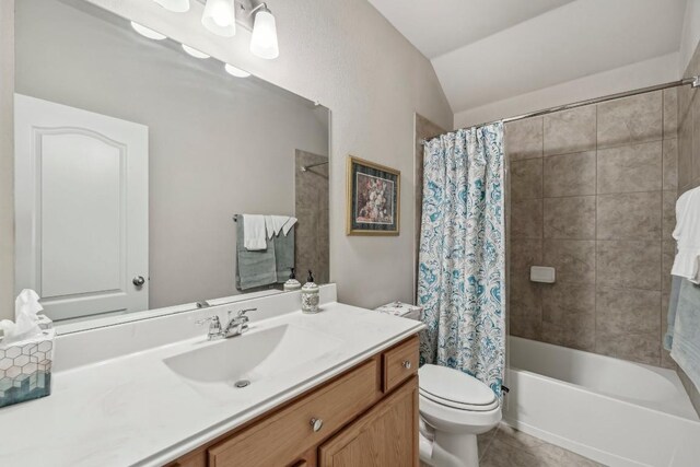 full bathroom featuring lofted ceiling, shower / bathtub combination with curtain, tile patterned flooring, vanity, and toilet