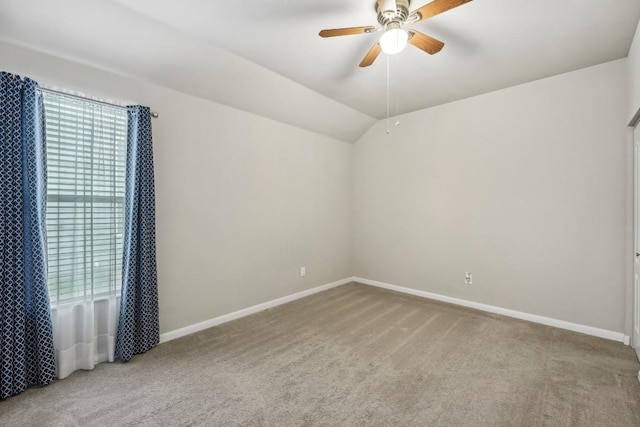 carpeted empty room with lofted ceiling and ceiling fan