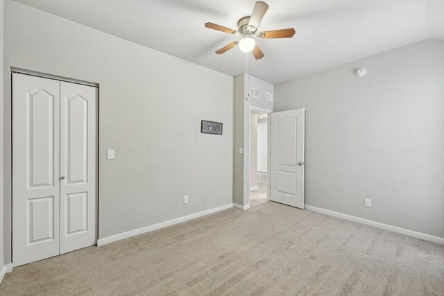 unfurnished bedroom with ceiling fan, a closet, and light carpet