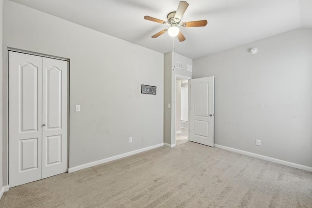 unfurnished bedroom with light colored carpet, a closet, and ceiling fan