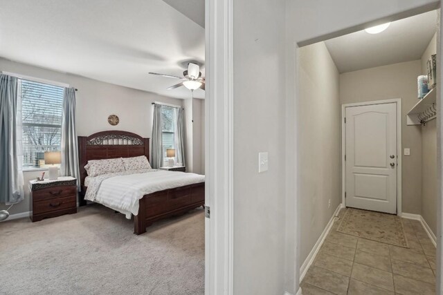 tiled bedroom featuring ceiling fan