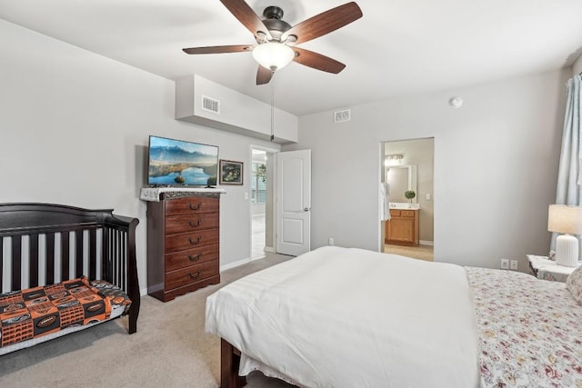 carpeted bedroom featuring connected bathroom and ceiling fan