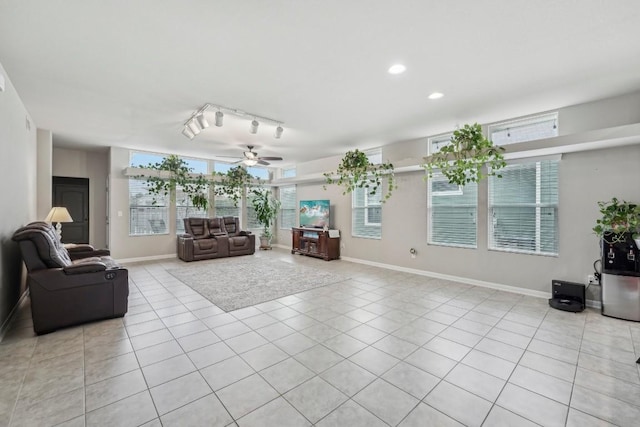 living room featuring rail lighting, light tile patterned floors, and ceiling fan