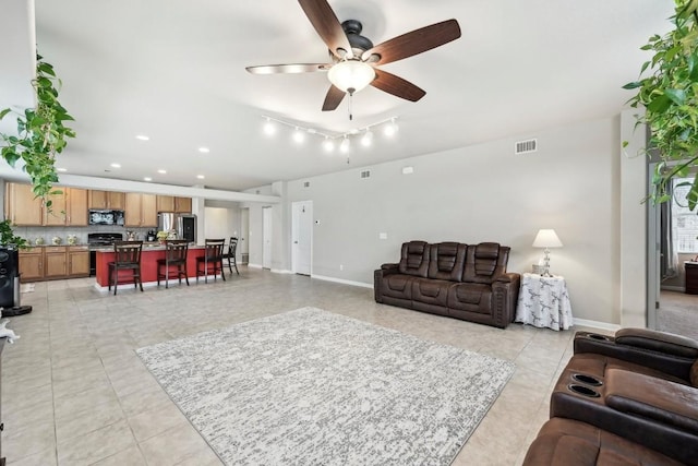 living room with ceiling fan and light tile patterned floors