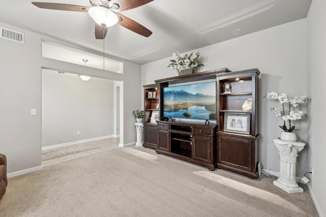 living room with light colored carpet and ceiling fan