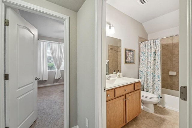 full bathroom with shower / tub combo with curtain, tile patterned flooring, vanity, vaulted ceiling, and toilet