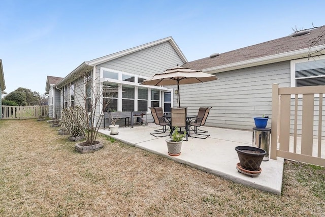 rear view of house featuring a yard and a patio