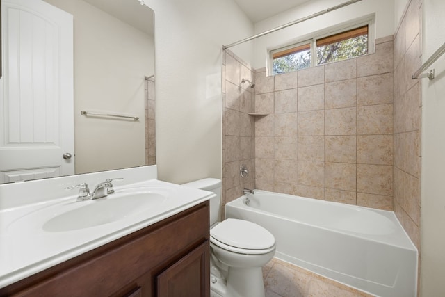 full bathroom featuring tiled shower / bath, vanity, and toilet