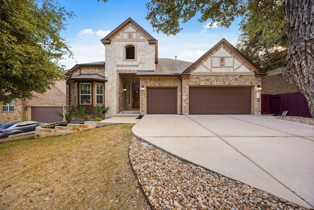 view of front of home with a garage and a front lawn