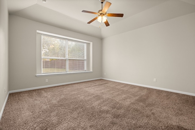 carpeted empty room with ceiling fan and lofted ceiling