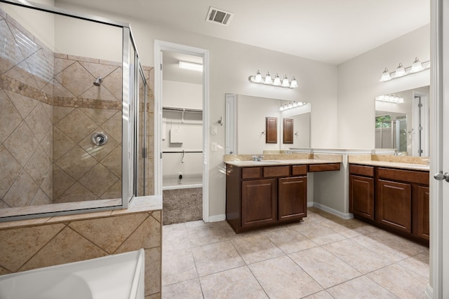 bathroom with tile patterned floors, vanity, and separate shower and tub