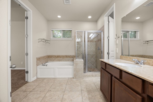 bathroom featuring a healthy amount of sunlight, separate shower and tub, and tile patterned flooring