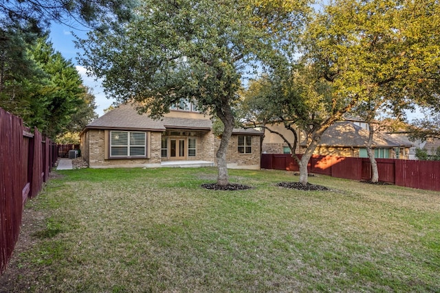 back of house with a yard