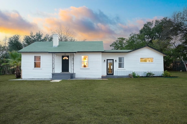 ranch-style house featuring a lawn