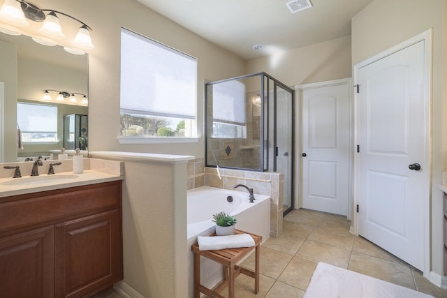 bathroom featuring vanity, tile patterned flooring, and shower with separate bathtub