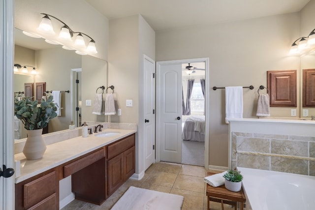 bathroom featuring tile patterned flooring, vanity, and a tub