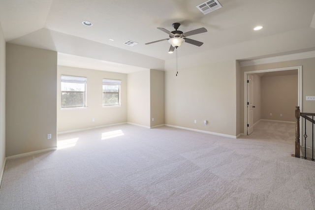 carpeted spare room featuring ceiling fan