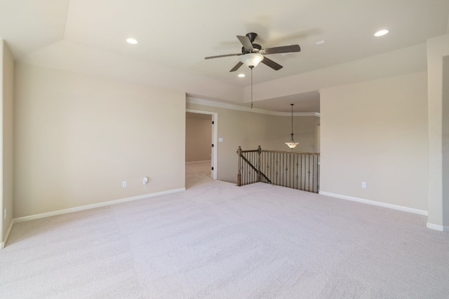 unfurnished room with light colored carpet and ceiling fan