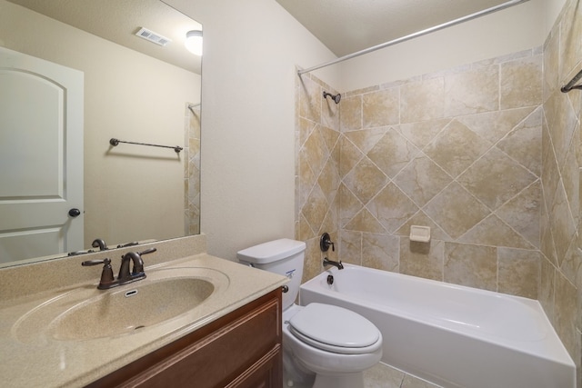 full bathroom with tiled shower / bath, vanity, and toilet