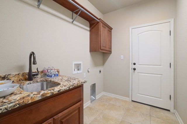 clothes washing area with sink, light tile patterned floors, electric dryer hookup, hookup for a washing machine, and cabinets