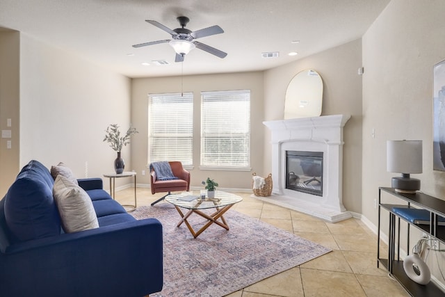 living room with ceiling fan and light tile patterned flooring