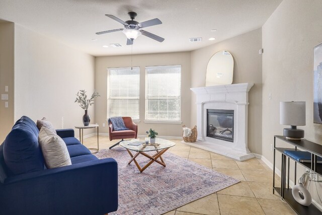 5025 Patagonia Pass, Austin, TX 78738 - living room with a ceiling fan, tile patterned flooring, and a glass covered fireplace