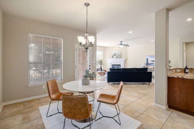 5025 Patagonia Pass, Austin, TX 78738 - dining area featuring a glass covered fireplace, a ceiling fan, light tile patterned floors, a chandelier, and recessed lighting