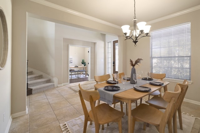 tiled dining space featuring crown molding and a chandelier