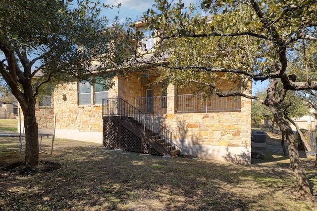 5025 Patagonia Pass, Austin, TX 78738 - view of home's exterior with stone siding and stairs