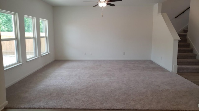 spare room with ceiling fan and carpet