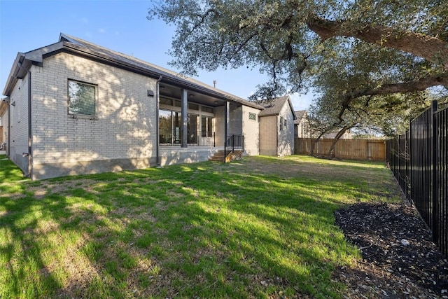 back of house with a lawn