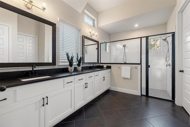 bathroom with vanity, tile patterned flooring, and a shower with door