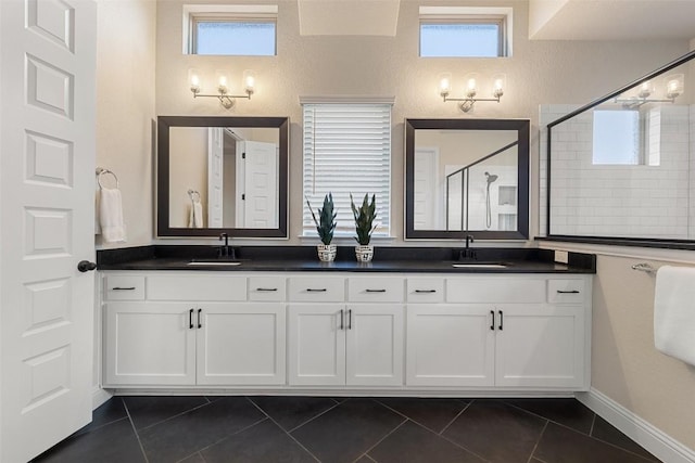 bathroom with an enclosed shower, vanity, and tile patterned floors