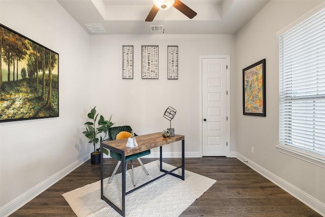 office with a raised ceiling, ceiling fan, and dark hardwood / wood-style flooring