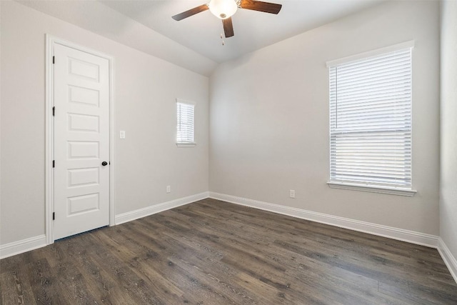 empty room featuring lofted ceiling, dark hardwood / wood-style floors, and ceiling fan