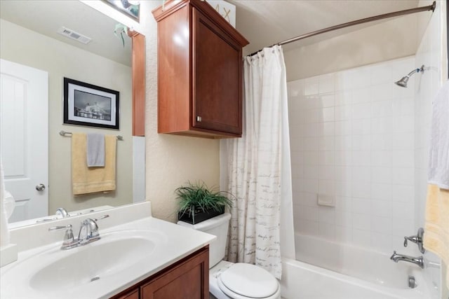 full bathroom with vanity, shower / bath combination with curtain, and toilet