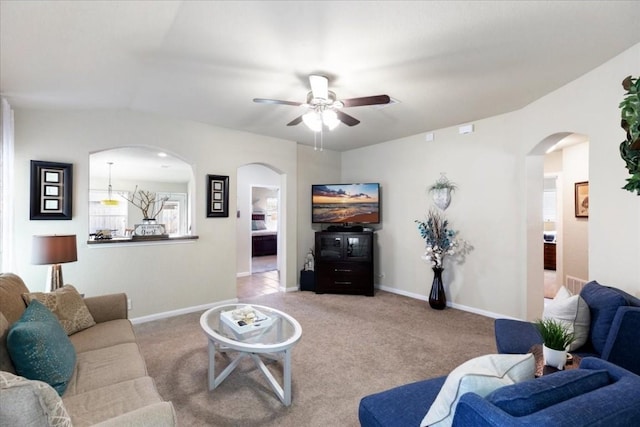 carpeted living room featuring ceiling fan