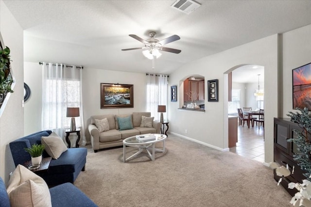 carpeted living room featuring ceiling fan