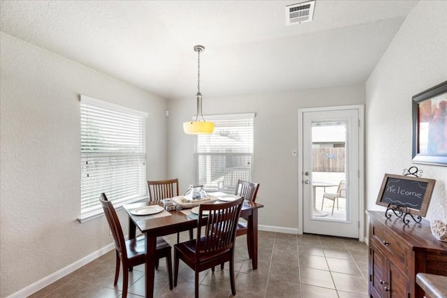 dining space featuring tile patterned flooring