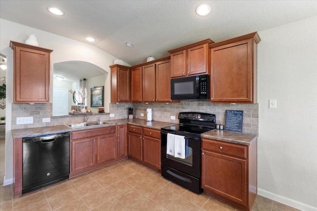 kitchen featuring lofted ceiling, sink, tasteful backsplash, light tile patterned floors, and black appliances